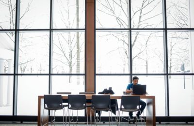 Students studies in the common area of the John Lyons Building