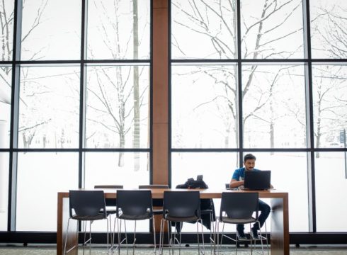 Students studies in the common area of the John Lyons Building