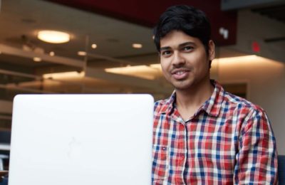 Male international student studies at his laptop