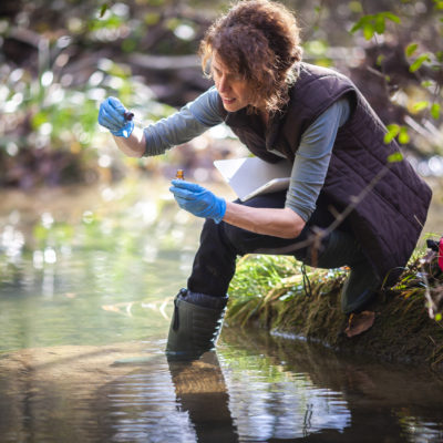 Conservation biology student gathering water samples