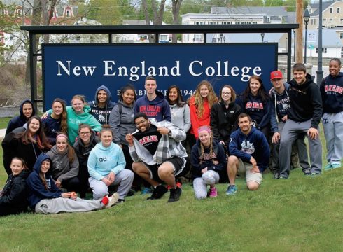Students at the main NEC sign in Henniker
