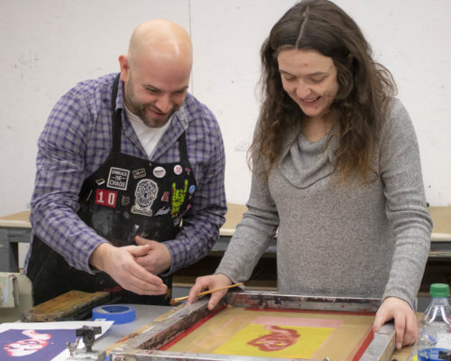 Faculty and student working in the printmaking lab