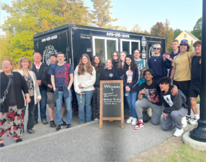 High school students pose in front of a food truck at NEC