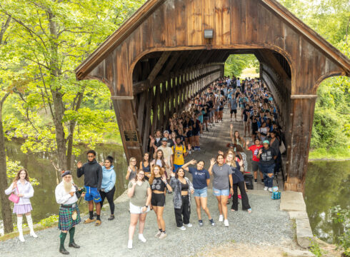 Students walk across the covered bridge before Convocation.