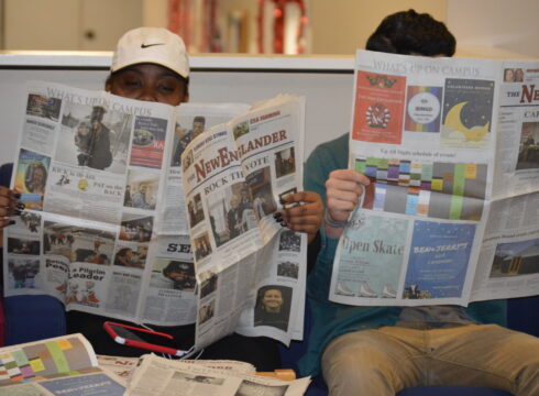 Students reading The NewEnglander, New England College's student-run newspaper