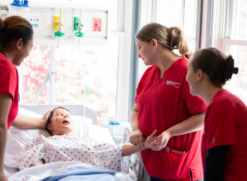 Nursing students at New England College practice their bedside nursing skills.