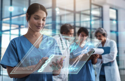 A nurse uses health informatics to deliver patient care.