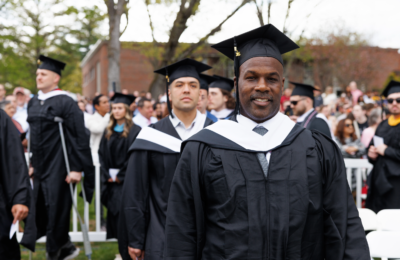 Student proceeds into the 2025 Commencement ceremony at New England College.