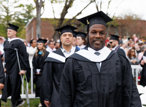 Student proceeds into the 2025 Commencement ceremony at New England College.