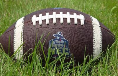 Image of a football with the New England College logo