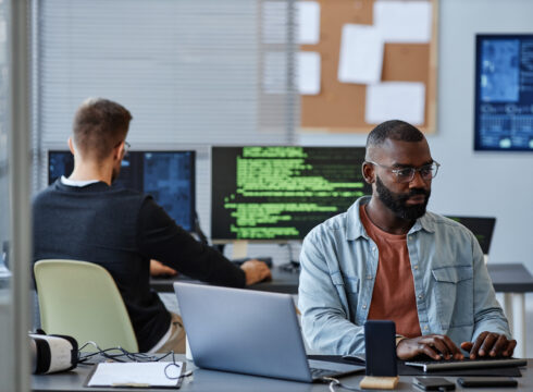A computer information systems professional works at his computer.