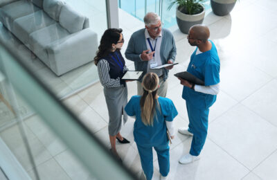 Healthcare managers speak with doctors in a hospital