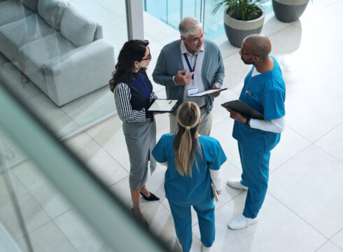 Healthcare managers speak with doctors in a hospital