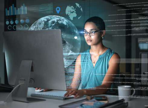 AI strategist works at a computer.