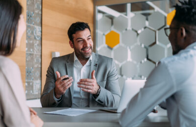 A marketing manager talks with marketing team members.