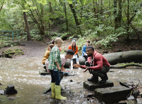 An environmental educator teaching children about wildlife.