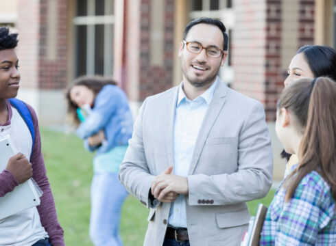 School principal interacts with students
