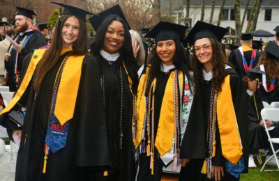 Four graduating students at New England College's Commencement ceremony on May 2, 2026