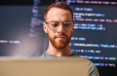 An AI professional working on a computer.