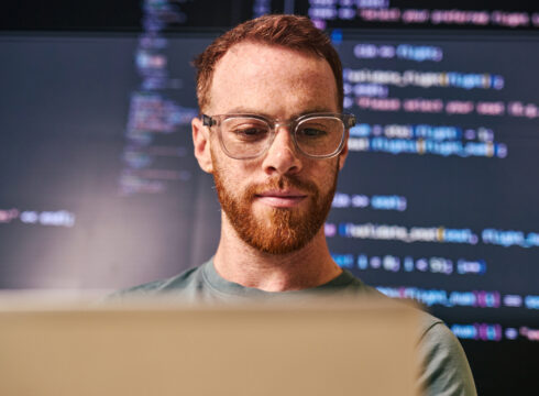 An AI professional working on a computer.