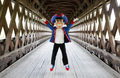 Patty the Pilgrim on the covered bridge at New England College in Henniker, NH