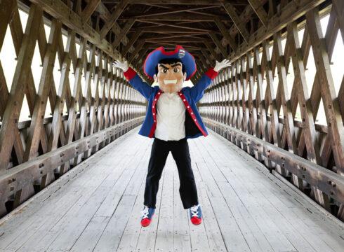 Patty the Pilgrim on the covered bridge at New England College in Henniker, NH