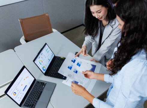 Market research analysts review customer data.