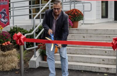 Lex Scourby cuts the ribbon for the new Athletics Center at New England College in Henniker, NH.