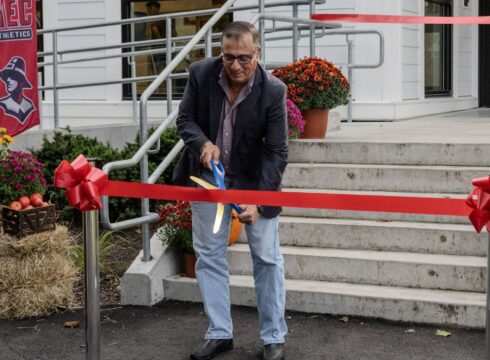 Lex Scourby cuts the ribbon for the new Athletics Center at New England College in Henniker, NH.